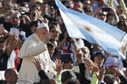Argentina's flag is seen as Pope Francis greets the crowd during his general audience in St. Peter's Square at the Vatican on Oct. 11. (CNS photo/Paul Haring)