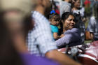 A woman holds a child during an immigration rally near the U.S. Capitol in Washington Sept. 26. (CNS photo/Tyler Orsburn)