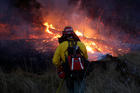 A firefighter battles a wildfire on Oct. 14 near Santa Rosa, Calif. The fire claimed the lives of more than 40 people. (CNS photo/Jim Urquhart, Reuters)