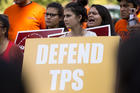 A woman holds a sign showing her support for Temporary Protected Status, or TPS, during a rally near the U.S. Capitol in Washington on Sept. 26. Bishop Joe S. Vasquez of Austin, Texas, chairman of the U.S. bishops' migration committee, told the U.S. government on Oct. 17 that current TPS recipients from El Salvador and Honduras "cannot return to safely to their home country at this time" and urged their TPS status be extended. (CNS photo/Tyler Orsburn)