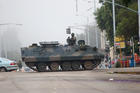 An army tanker blocks the main road to Parliament building on Nov. 15 in Harare, Zimbabwe. (CNS photo/Aaron Ufumeli, EPA)