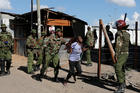 A police officer pushes a supporter of the Kenyan National Super Alliance during clashes Nov. 28 in Nairobi. Kenyan police fired tear gas and clashed with both ruling party and opposition supporters as President Uhuru Kenyatta was sworn in for a second term. Two disputed polls left the nation deeply divided. (CNS photo/Thomas Mukoya, Reuters)