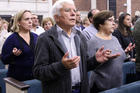 Worshippers recite the Lord's Prayer during Mass at Corpus Christi Church in Mineola, N.Y., on Oct. 13. (CNS photo/Gregory A. Shemitz, Long Island Catholic)