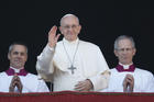 Pope Francis waves as he arrives to deliver his Christmas message and blessing "urbi et orbi" (to the city and the world) from the central balcony of St. Peter's Basilica at the Vatican on Dec. 25. (CNS photo/Paul Haring) 