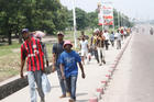 People walk as traffic is blocked by security forces Dec. 31 in Kinshasa, Congo. Church leaders in Congo have expressed "profound shock" after security forces fired on Catholics protesting rule by President Joseph Kabila, leaving at least eight dead. (CNS photo/Kenny Katombe, Reuters)