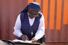 A woman religious fills out a voter registration document on Jan. 31 in Abuja, Nigeria, for the country's 2019 presidential and general election. (CNS photo/Afolabi Sotunde, Reuters)