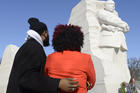 Aaron Brown of Houston and Arielle Phillips of Charlotte, N.C., pause to view a 30-foot sculpture of the Rev. Martin Luther King Jr. in Washington Jan. 19. (CNS photo/Mike Theiler, Reuters)