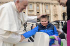 Pope Francis greets Peter Lombardi, 12, of Columbus, Ohio, after the boy rode in the popemobile during his general audience in St. Peter's Square at the Vatican March 28. Receiving a kiss from the pope was a wish come true for Peter, who has Down syndrome and has survived leukemia. (CNS photo/Vatican Media)