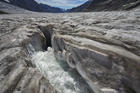 Water from the melting Aletsch Glacier in the Swiss Alps runs down through a hole in 2015. While everyone has a role and responsibility to help safeguard the planet, all governments must uphold commitments agreed upon in the Paris Accord on reducing climate change, Pope Francis said. (CNS photo/Denis Balibouse, Reuters)