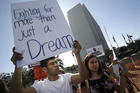 A protester holds a sign that reads "Fighting for more than just a Dream," as he joined Dreamers and hundreds of demonstrators calling for Deferred Action for Childhood Arrivals, or DACA, in early February outside the Federal Building in Los Angeles. (CNS photo/Mike Nelson, EPA