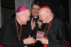 Archbishop Carlo Maria Vigano, then nuncio to the United States, congratulates then-Cardinal Theodore E. McCarrick of Washington at a gala dinner sponsored by the Pontifical Missions Societies in New York in May 2012. The archbishop has since said Cardinal McCarrick already was under sanctions at that time, including being banned from traveling and giving lectures. Oblate Father Andrew Small, center, director of the societies, said Archbishop Vigano never tried to dissuade him from honoring the cardinal at 