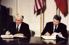 Soviet President Mikhail Gorbachev and U.S. President Ronald Reagan sign the Intermediate-Range Nuclear Forces treaty at the White House in Washington Dec. 8 1987. (CNS photo/Reuters)