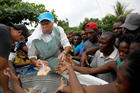 A member of the Missionaries of the Risen Christ provides migrants with food in Tapachula, Mexico, May 11, 2019. Some African and Haitian migrants have been stranded in southern Mexico for two months. (CNS photo/Andres Martinez Casares, Reuters)