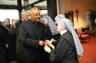 Archbishop Wilton D. Gregory greets a Little Sister of the Poor at the Jeanne Jugan Residence the order operates for the elderly poor in Washington April 5, 2019. (CNS photo/Jaclyn Lippelmann, Catholic Standard)