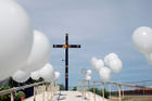 An altar is adorned with white balloons at a "Mass for the Peace" Aug. 10, 2019, in Ciudad Juarez, Mexico, one week after a mass shooting at a Walmart store in nearby El Paso, Texas. (CNS photo/Jose Luis Gonzalez, Reuters) 