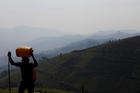 A man carries water in the mountains near Goma, Congo, Aug. 14, 2019. A representative of the Catholic bishops of Congo have called on multinational corporations working in the mineral-rich country to contribute toward local development. (CNS photo/Baz Ratner, Reuters) 