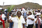 A woman waves palm fronds as people wait for the arrival of Pope Francis to celebrate Mass at the monument to Mary, Queen of Peace in Port Louis, Mauritius, Sept. 9, 2019. (CNS photo/Paul Haring)