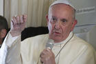 Pope Francis answers questions from journalists aboard his flight from Antananarivo, Madagascar, to Rome on Sept. 10. (CNS photo/Paul Haring)