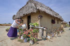 Celestina Fernandes da Silva, a Catholic activist, waters flowers in front of her home in the Wapishana indigenous village of Tabalascada, Brazil, on April 3, 2019. (CNS Photo/Paul Jeffrey) 