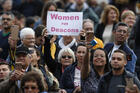 A woman holds a sign in support of women deacons as Pope Francis leads his general audience in St. Peter's Square at the Vatican on Nov. 6. (CNS photo/Paul Haring)