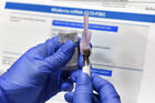 A nurse prepares a shot as a study of a possible Covid-19 vaccine, developed by the National Institutes of Health and Moderna Inc., on July 27 in Binghamton, N.Y. (AP Photo/Hans Pennink)