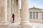 Surveying the world from beneath the columns of the Academy of Athens, in Greece. (iStock/sarra22)