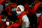 Rescued migrants look out from an Armed Forces of Malta vessel upon their arrival in Valletta, Malta, Aug. 3, 2020. (CNS photo/Darrin Zammit Lupi, Reuters)