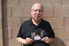 Auska Mitchell holds a photograph of his nephew, Lezmond Mitchell, on Aug. 21 in the Phoenix area. Lezmond Mitchell is scheduled to be executed this Wednesday, Aug. 26. (AP Photo/Jonathan J. Cooper)