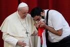 A masked Maronite Father Georges Briedi kisses the hand of Pope Francis as the two men hold a Lebanese flag during the pope's weekly general audience at the Vatican Sept. 2, 2020. (CNS photo/Guglielmo Mangiapane, Reuters)