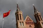 The Chinese national flag is pictured in a file photo in front of a Catholic church in the village of Huangtugang. (CNS photo/Thomas Peter, Reuters)