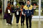 Somali refugees are escorted by a United Airlines representative as they arrive at the airport on Feb. 13, 2018, in Boise, Idaho. (CNS photo/Brian Losness, Reuters)