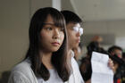 In this Friday, Aug. 30, 2019, photo, pro-democracy activists Joshua Wong, right, and Agnes Chow speak to media outside a district court in Hong Kong. Wong, Chow and activist Ivan Lam have been sentenced to jail on Wednesday, over charges related to an unauthorized anti-government protest last year at the city's police headquarters. (AP Photo/Kin Cheung)