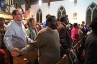 People join hands during a service at St. Katharine Drexel Church in Chester, Pa. In a March 12, 2020, announcement, the Philadelphia Archdiocese said Catholics in the archdiocese who do not wish to attend Sunday Mass for fear of spreading or contracting coronavirus are no longer obligated to do so, until further notice. (CNS photo/Sarah Webb, CatholicPhilly.com)