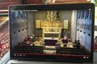 A viewer watches a livestream Mass from the Cathedral of Mary Our Queen in Baltimore celebrated by Baltimore Archbishop William E. Lori and a few concelebrants March 15, 2020. All Sunday Masses in the Archdiocese of Baltimore were canceled amid coronavirus pandemic concerns. (CNS photo/Ann M. Augherton, Arlington Herald)