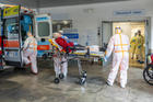 Medical workers at Gemelli Hospital in Rome wear protective suits as they attend an elderly coronavirus patient on March 16, 2020. (CNS photo/Policlinico Gemelli, handout via Reuters)