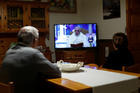  People watch television at a home in Cisternino, Italy, as Pope Francis gives his extraordinary blessing "urbi et orbi" (to the city and the world) from the atrium of St. Peter's Basilica at the Vatican March 27, 2020. The blessing was livestreamed because of the coronavirus pandemic. (CNS photo/Alessandro Garofalo, Reuters)