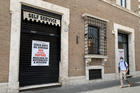 A man walks past a coffee bar and cafeteria on the Via della Conciliazione near the Vatican June 9, 2020. The sign in the window says, "Without government help, we cannot reopen. Thousands of employees at risk." (CNS photo/Cindy Wooden) 