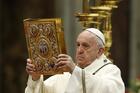 Pope Francis raises the Book of the Gospels as he celebrates Mass marking the feast of the Epiphany in St. Peter's Basilica at the Vatican