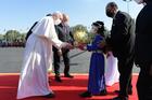 Pope Francis receives flowers from children during a welcoming ceremony with Iraqi President Barham Salih at the presidential palace in Baghdad on March 5, 2021. (CNS photo/Vatican Media)