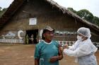 An Indigenous man receives the AstraZeneca/Oxford COVID-19 vaccine from a municipal health worker in the Sustainable Development Reserve of Tupe in Manaus, Brazil, Feb. 9, 2021. (CNS photo/Bruno Kelly, Reuters)