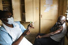 A man prepares for his AstraZeneca COVID-19 vaccine at Ndirande Health Centre in Blantyre, Malawi on March 29. (AP Photo/Thoko Chikondi, File)