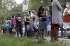 People wait outside a vaccination station to receive a dose of the Sinovac CoronaVac COVID-19 vaccine in Belford Roxo, Brazil, March 31, 2021, during a vaccination day for citizens 71 and older. (CNS photo/Ricardo Moraes, Reuters)