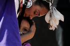 A woman embraces her daughter during a rally at the former Kamloops Indian Residential School in Kamloops, British Columbia, June 6, 2021. The remains of 215 children, some as young as three years old, were detected by ground-penetrating radar found at the site in May. (CNS photo/Chris Helgren, Reuters)