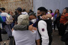 In this July 5, 2021, file photo, Alex Cortillo, from Honduras, gets a hug from Erika Valladares Ponce, also from Honduras, in Tijuana, Mexico, as he waits to cross into the United States to begin the asylum process. (AP Photo/Gregory Bull, File)
