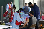 In this Jan. 13, 2021, file photo, health care workers receive a Covid-19 vaccination at Ritchie Valens Recreation Center, in Pacoima, Calif. California will require all of its roughly 2.2 million health care and long term care workers to be fully vaccinated against the coronavirus by Sept. 30. (AP Photo/Marcio Jose Sanchez, File)