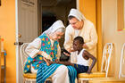 Felician Sisters Marilyn Minter and Inga Borko treat a young patient in Jacmel. Photo courtesy of the Felician Sisters of North America