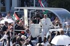 Pope Francis greets the crowd as he arrives to celebrate the closing Mass of the International Eucharistic Congress at Heroes' Square in Budapest, Hungary, Sept. 12, 2021. Also pictured in the popemobile is Cardinal Péter Erdo of Esztergom-Budapest. (CNS photo/Paul Haring)