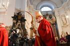 Bishop Georg Bätzing, wearing a red chasuble, carries a sharp-tipped crozier at the beginning of the autumn plenary meeting of German bishops.