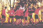 A scene from the film Dead Poets Society of students outside in gym gear carrying their professor, played by Robin Williams