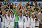 In this July 13, 2014 photo, Germany's Philipp Lahm holds up the World Cup trophy as the team celebrates their 1-0 victor over Argentina after the World Cup final soccer match between Germany and Argentina in Rio de Janeiro, Brazil. (AP Photo/Natacha Pisarenko)